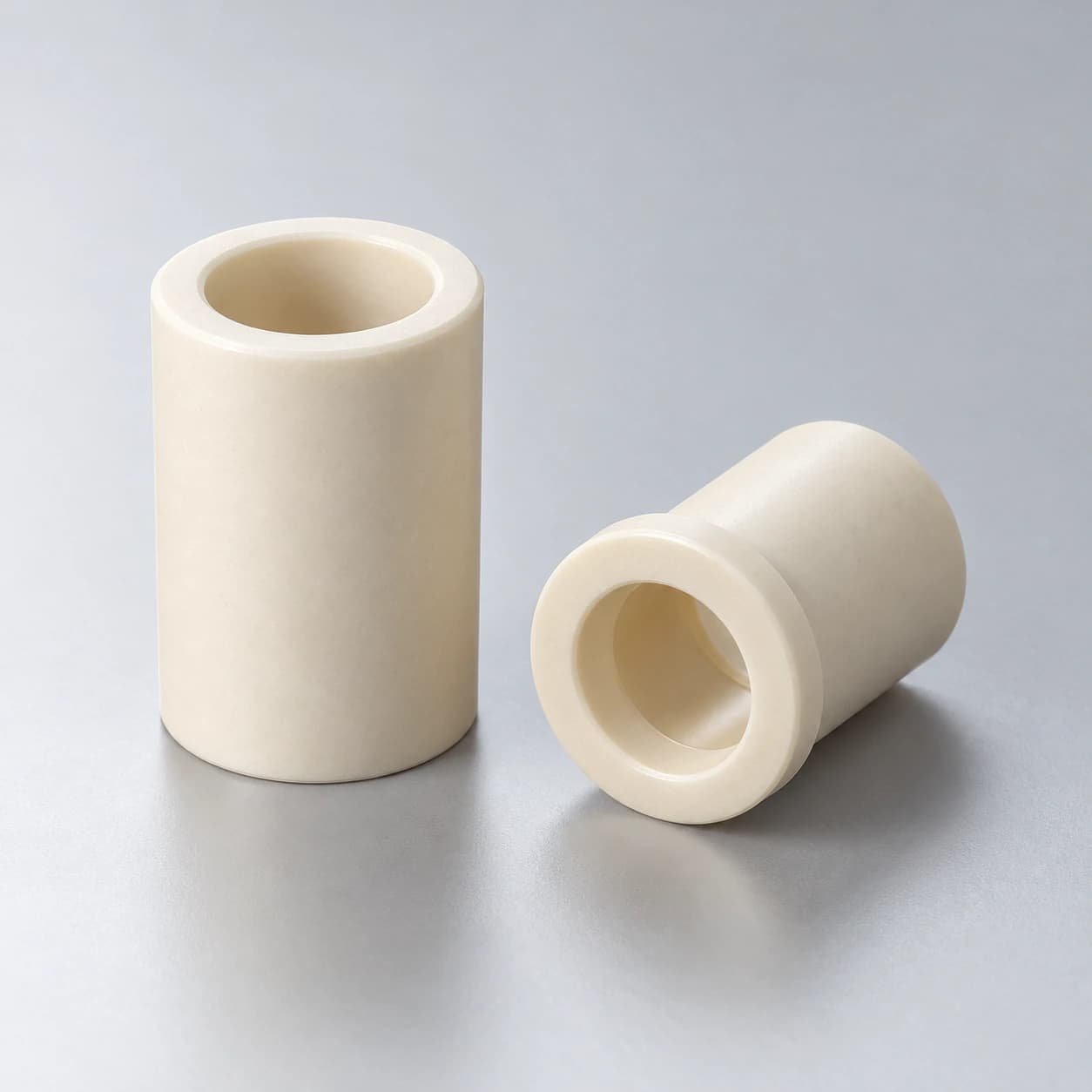 Illustrative ceramic sleeve and flanged guide bushing