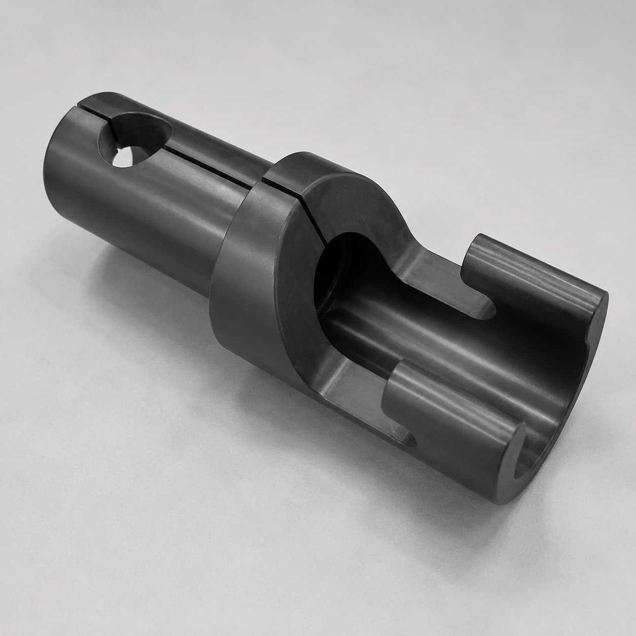 Silicon nitride structural component with a stepped body, open channel, longitudinal slot and transverse hole