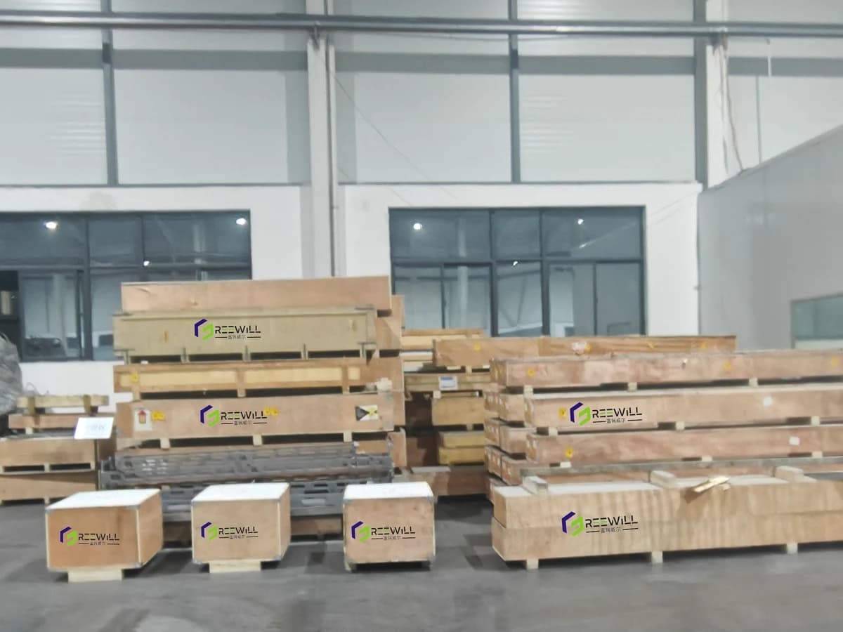 Wooden packing crates bearing FreeWill Material branding in the workshop