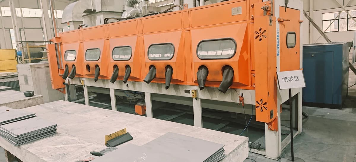Enclosed sandblasting cabinets with ceramic plates on nearby worktables