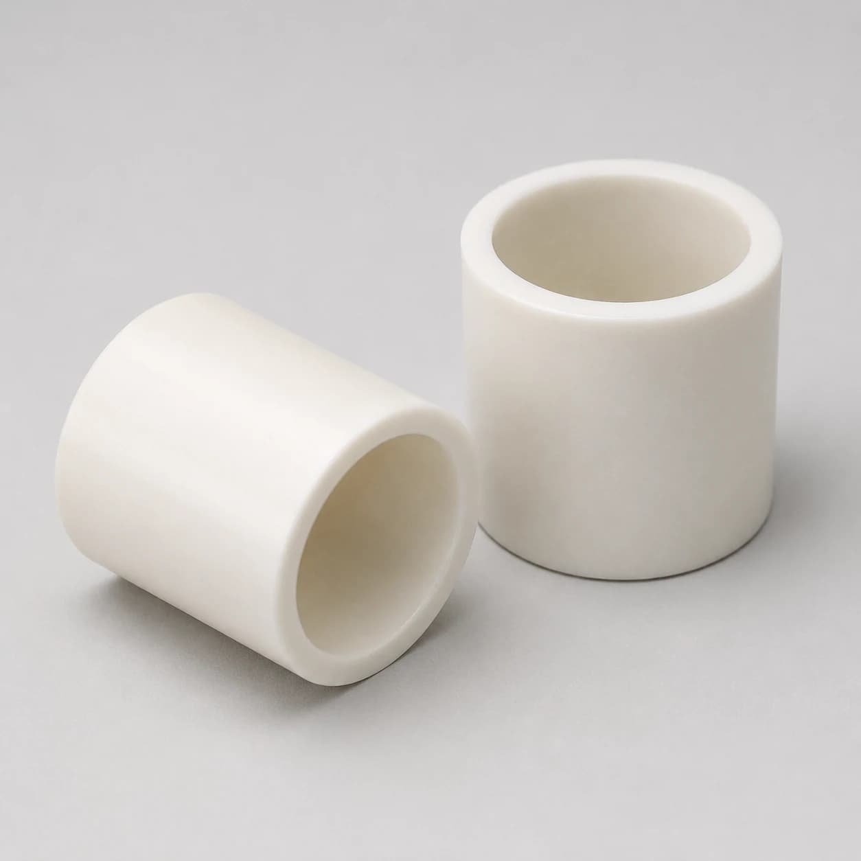 Two precision alumina ceramic bushings
