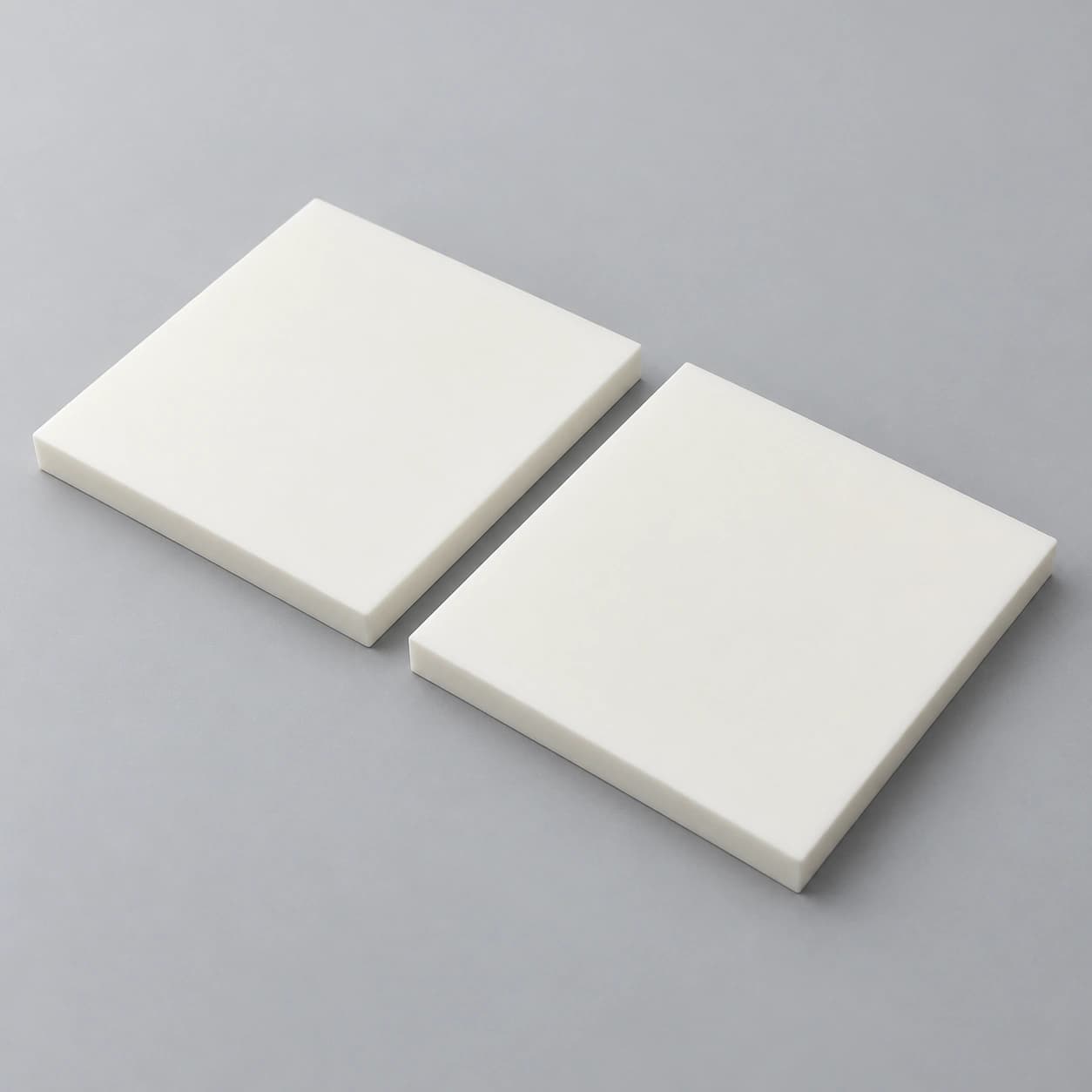 AI-generated concept of two plain square alumina structural plates on a neutral background