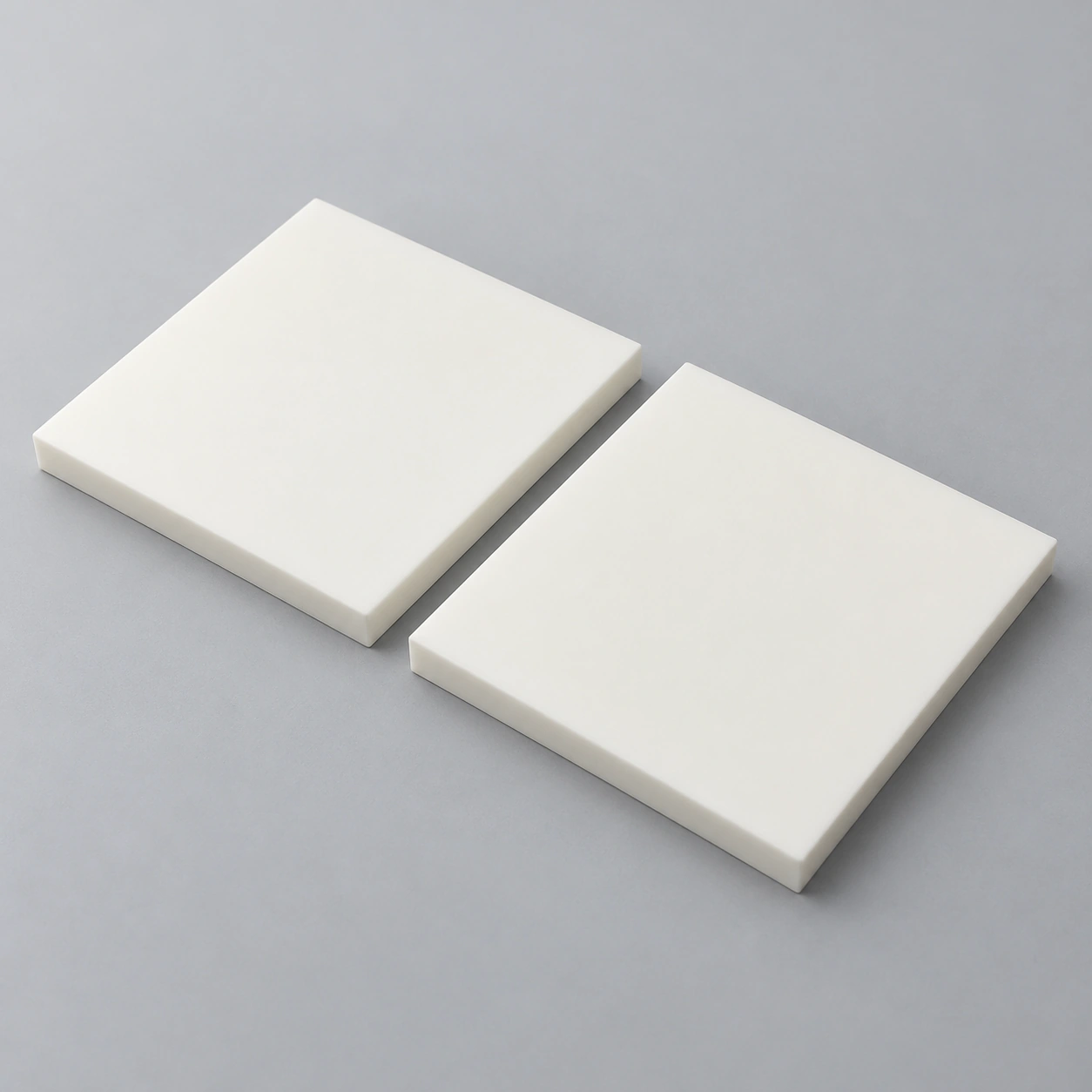 AI-generated concept of two plain square alumina structural plates on a neutral background