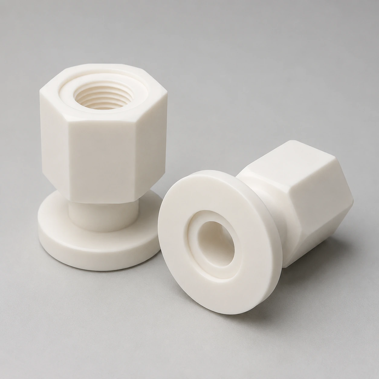 Two alumina custom components showing a threaded hexagonal body and flanged end