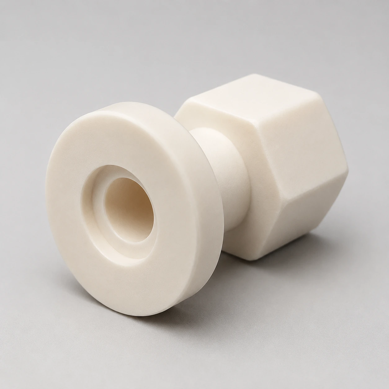 Angled view of an alumina custom component showing the flange and recessed bore