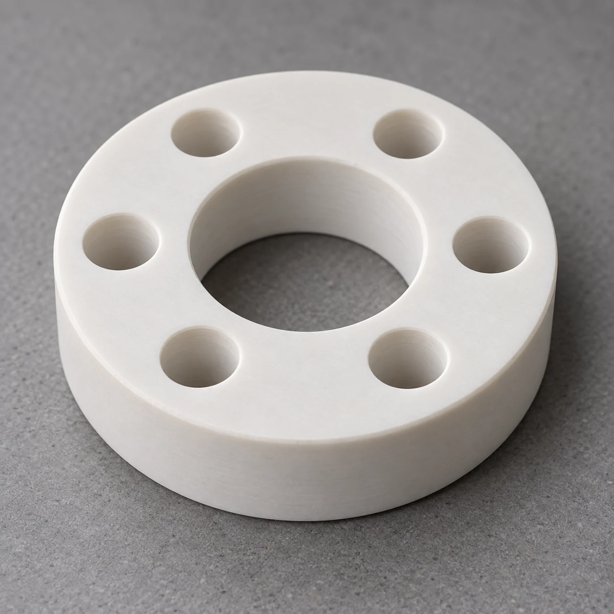 Boron nitride ring with central bore and six peripheral holes