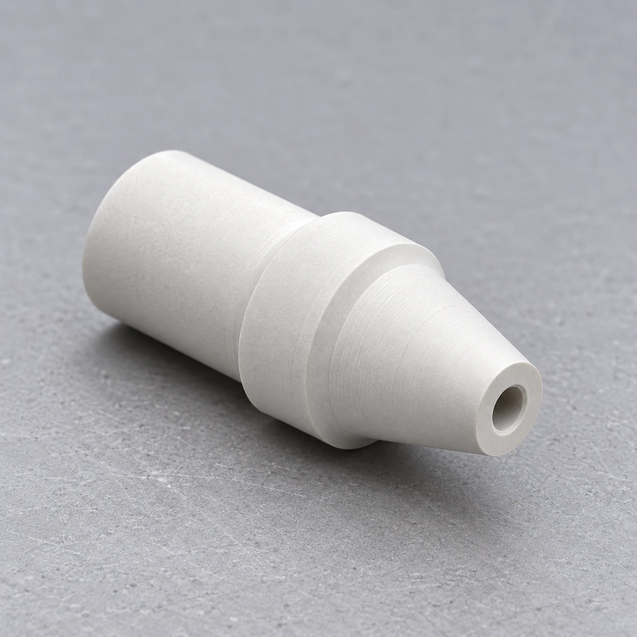 Tapered boron nitride nozzle with a central opening