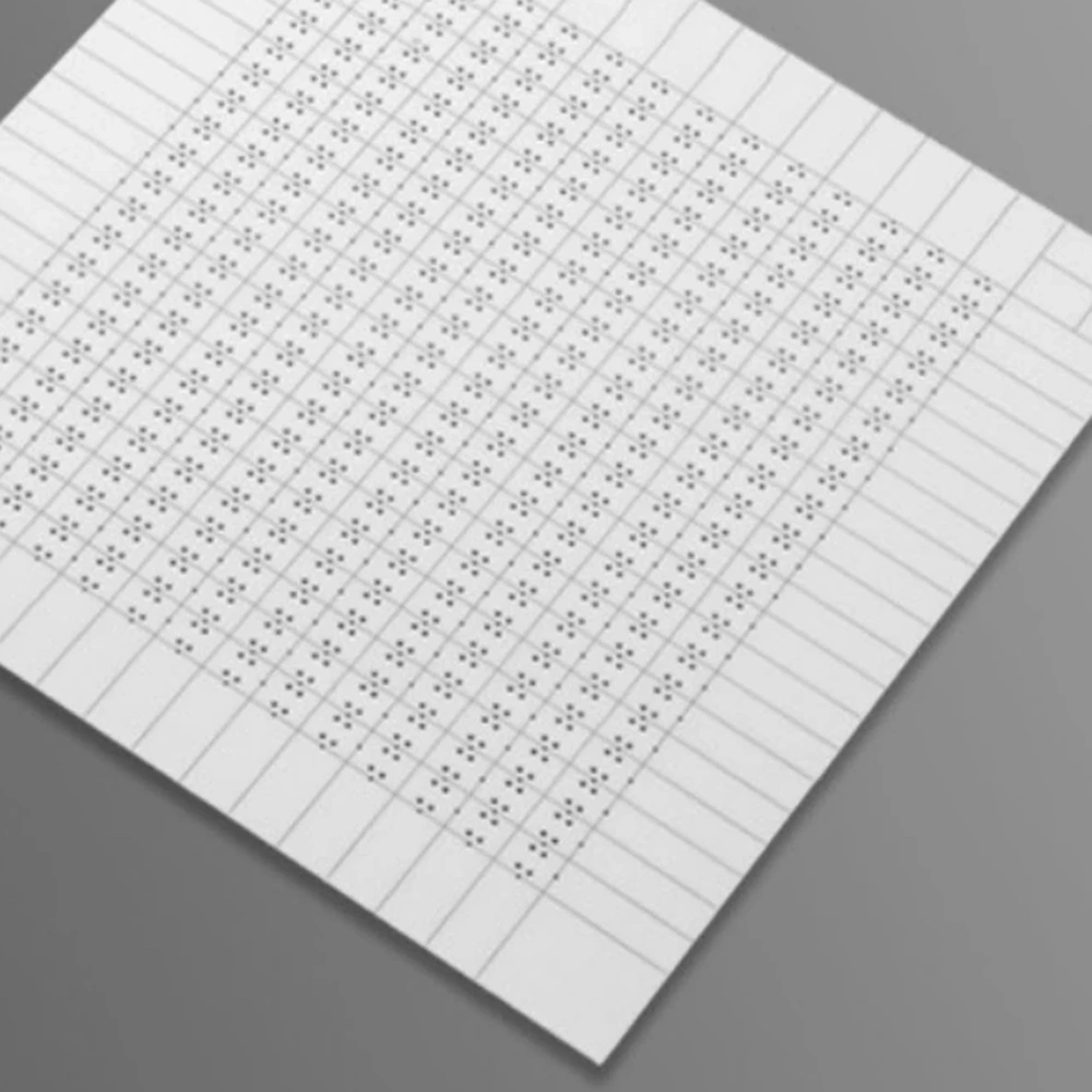 Detail view of alumina ceramic panel with repeated holes and separation lines