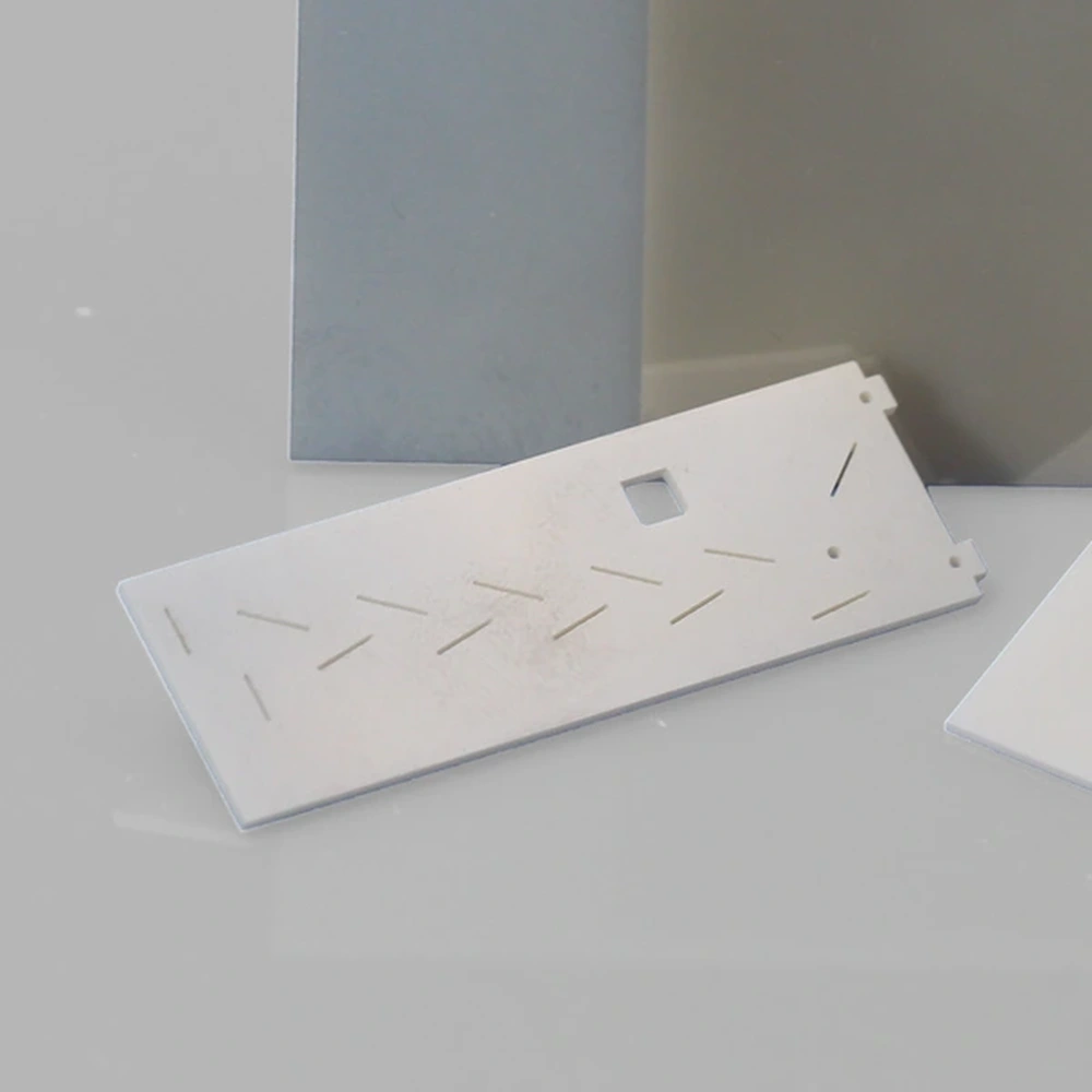 Detail view of machined AlN ceramic substrates with holes, slots and cut-outs