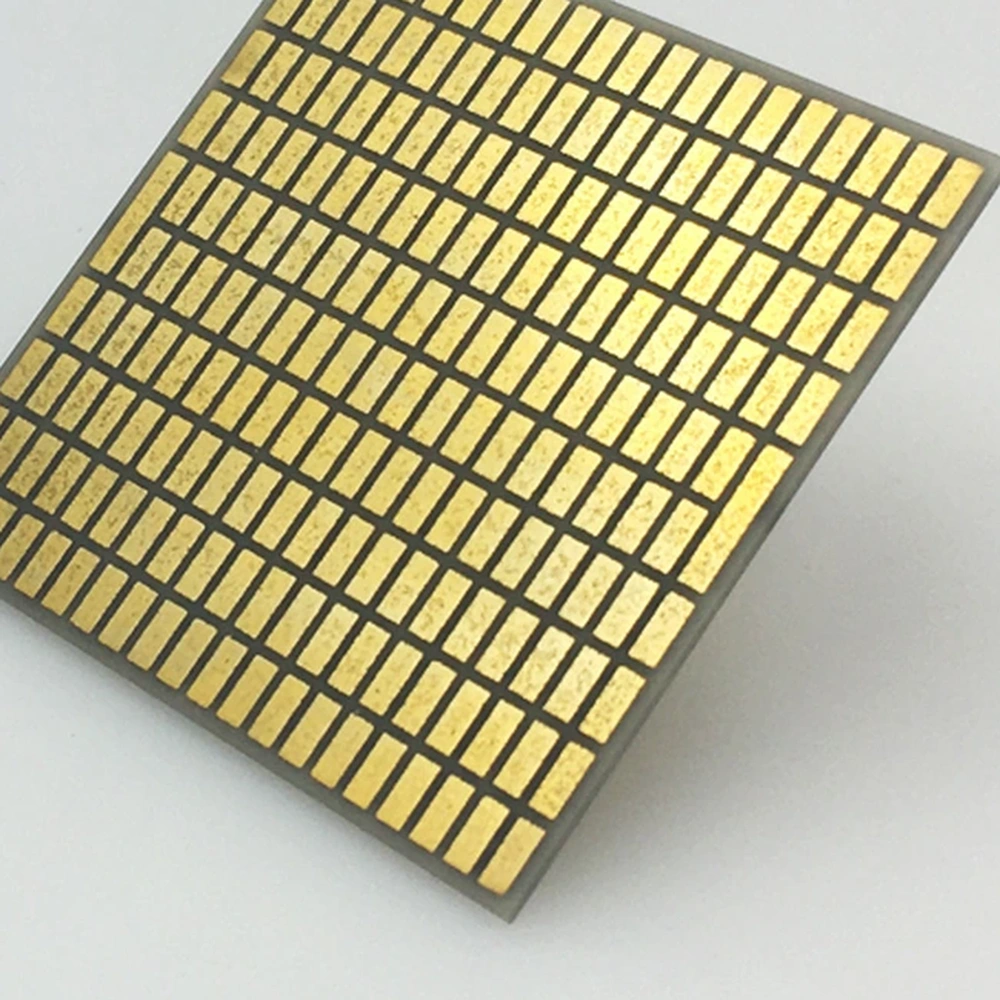 Detail view of gold-plated AlN DBC ceramic substrate with patterned pads