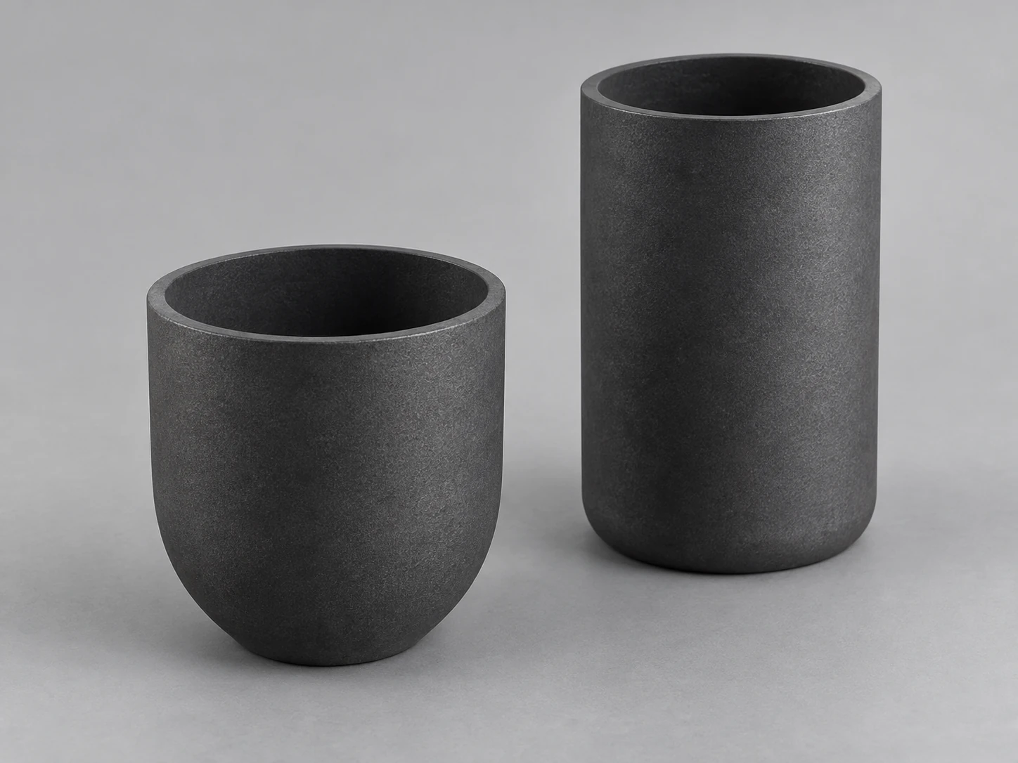 Conceptual silicon-carbide-containing foundry crucible family with standard curved-wall and tall cylindrical forms