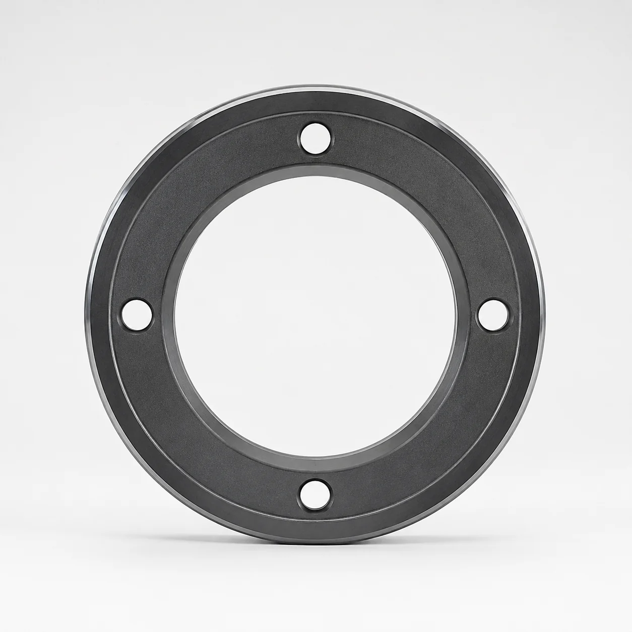 Front view of a silicon carbide mechanical seal ring with four mounting holes