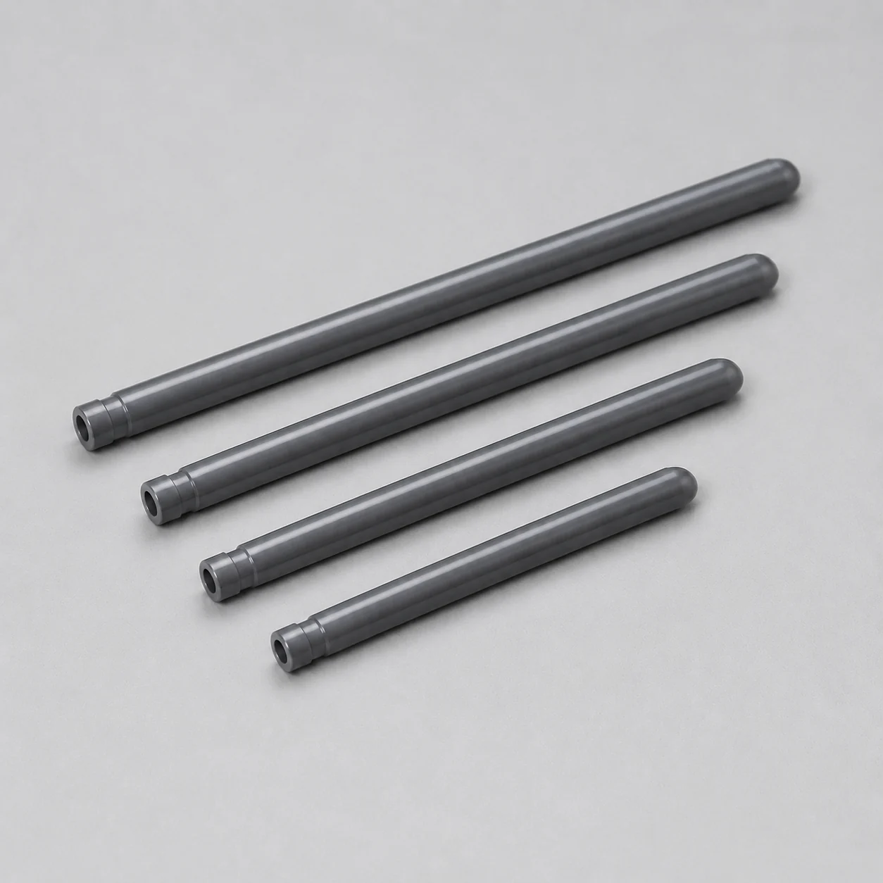 Four silicon nitride thermocouple protection tubes in different lengths