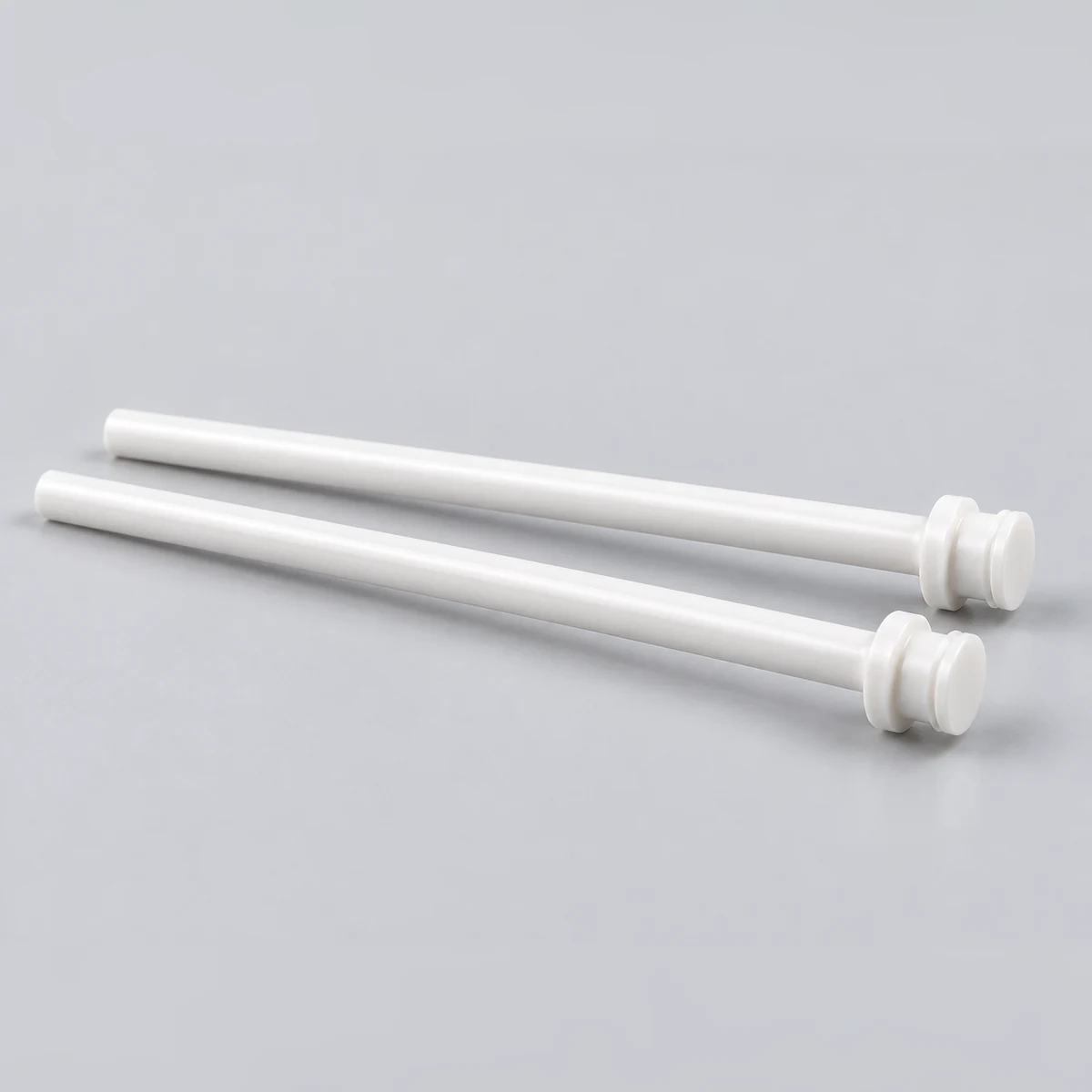 Two long zirconia ceramic shafts with stepped ends