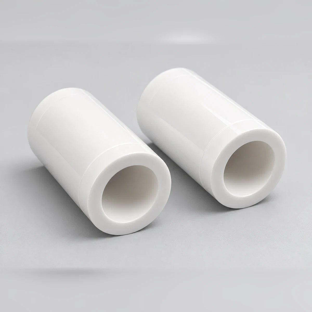 Two zirconia ceramic sleeves in an angled studio view