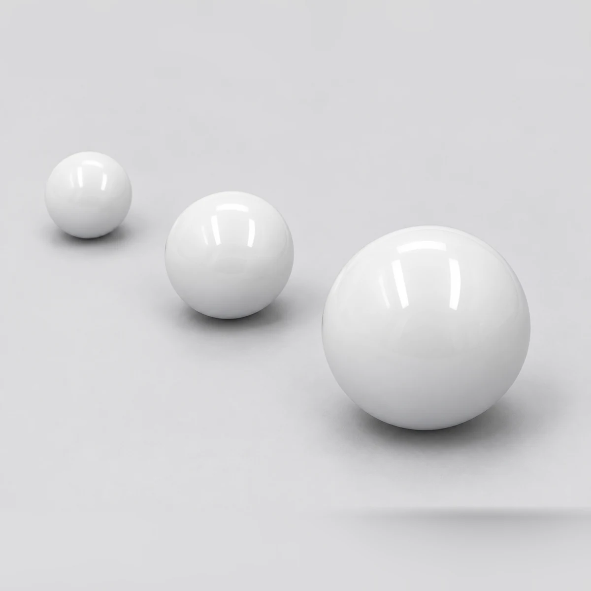 Three zirconia valve balls arranged by size
