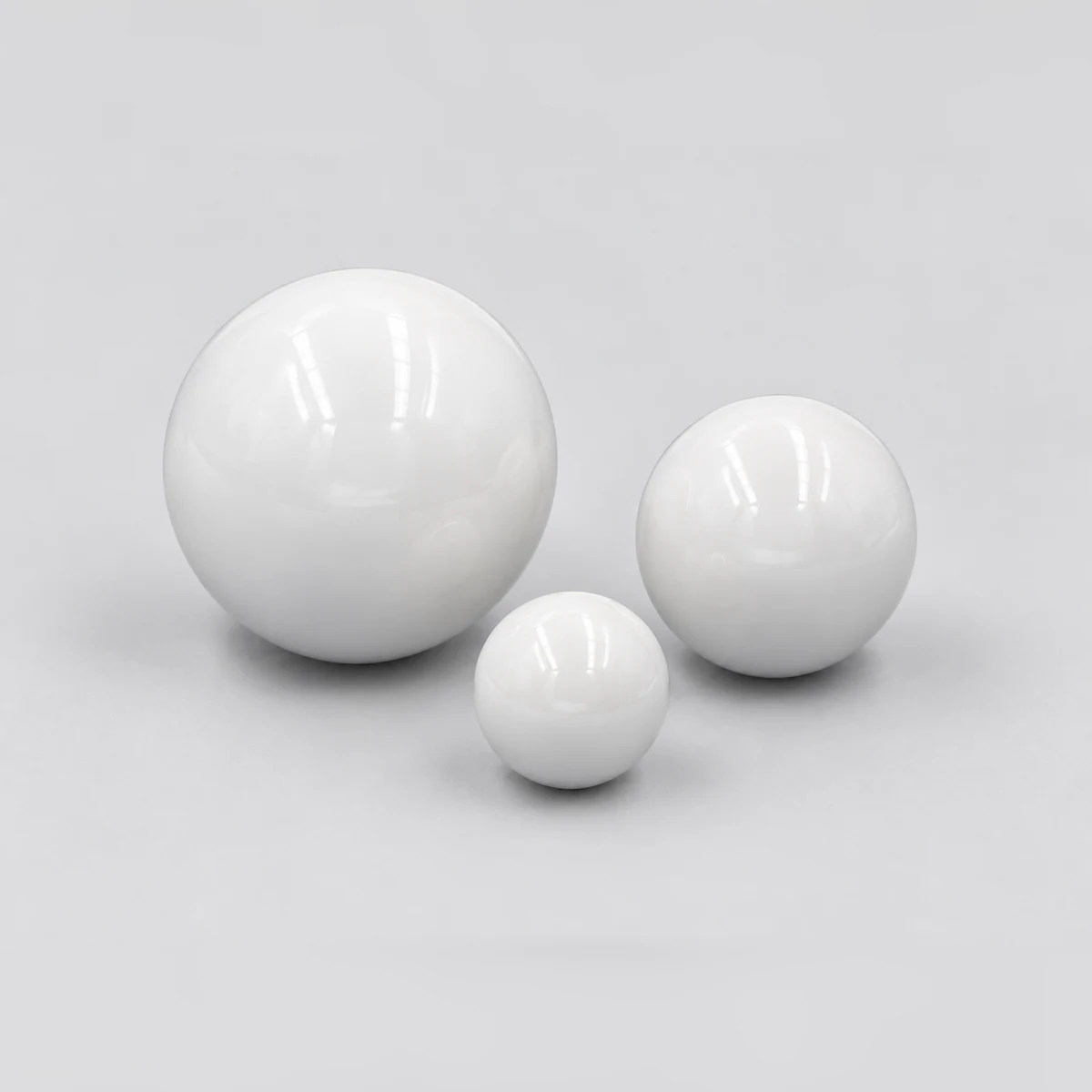 Three polished white zirconia valve balls